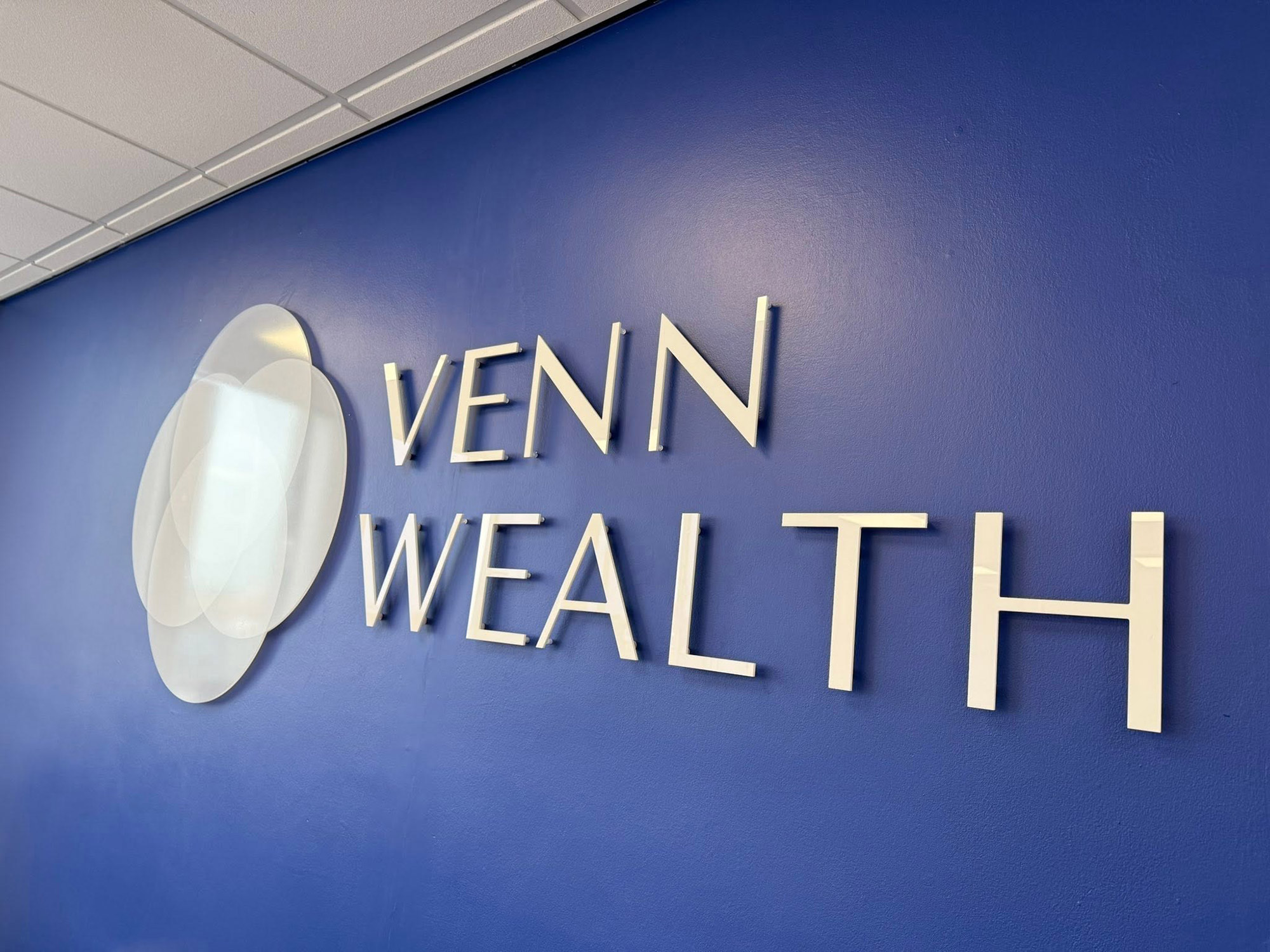 White sign on clear vinyl, letter cut in gloss white acrylic, installed with standoff fixings - design, fabrication and install from Engage Creative, l Stoke on Trent